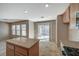 Open-concept kitchen featuring an island, stainless steel appliances, and sliding glass doors to the backyard at 4225 Ponce Royal Ave, North Las Vegas, NV 89031