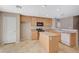 Well-lit kitchen offering stainless steel appliances, an island, and light wood cabinetry with ample storage space at 4225 Ponce Royal Ave, North Las Vegas, NV 89031