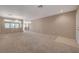 Large living space featuring neutral carpet, paint, and a tile entryway in an open floor plan at 4225 Ponce Royal Ave, North Las Vegas, NV 89031