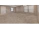 Bright and airy living room with neutral carpet, a white front door, and ample natural light at 4225 Ponce Royal Ave, North Las Vegas, NV 89031