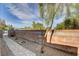 Long stone path in the side yard with a brick wall and small plants in circular mulch beds at 4225 Ponce Royal Ave, North Las Vegas, NV 89031