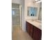 Bathroom featuring a shower and dual sink vanity providing practical and organized spaces at 4236 Thomas Patrick Ave, North Las Vegas, NV 89032