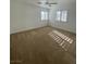 Carpeted bedroom with ceiling fan and windows providing natural light at 4236 Thomas Patrick Ave, North Las Vegas, NV 89032