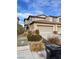 Tan two-story home with a well-manicured lawn, a two-car garage, and a brown roof at 4236 Thomas Patrick Ave, North Las Vegas, NV 89032