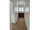 Hallway with carpet floors, built in cabinets, and natural light from window at 4236 Thomas Patrick Ave, North Las Vegas, NV 89032