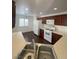 Efficient kitchen layout with wooden cabinets, white appliances, and a double sink at 4236 Thomas Patrick Ave, North Las Vegas, NV 89032