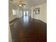 Spacious living room featuring dark hardwood floors and natural light from large windows at 4236 Thomas Patrick Ave, North Las Vegas, NV 89032