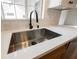 Close up of a kitchen sink, counter and faucet in a bright kitchen at 427 Wright Way, Henderson, NV 89015