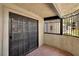 Private balcony featuring double glass doors, terra cotta tile and ornate wrought iron at 5070 Jeffreys St # 101, Las Vegas, NV 89119