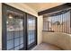 Private balcony featuring double glass doors, terra cotta tile and ornate wrought iron at 5070 Jeffreys St # 101, Las Vegas, NV 89119