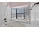 Close-up of a soaking tub beneath a window, surrounded by tile at 5070 Jeffreys St # 101, Las Vegas, NV 89119