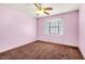 This cozy carpeted bedroom features a ceiling fan and a window offering ample light and a relaxing atmosphere at 5070 Jeffreys St # 101, Las Vegas, NV 89119