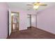 This carpeted bedroom features a ceiling fan, closet, and neutral paint, offering a cozy and comfortable space at 5070 Jeffreys St # 101, Las Vegas, NV 89119