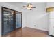Bright dining area with hardwood floors, a ceiling fan, and sliding glass doors to a balcony at 5070 Jeffreys St # 101, Las Vegas, NV 89119