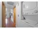 Hallway with wood floors and stacked washer and dryer at 5070 Jeffreys St # 101, Las Vegas, NV 89119