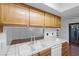 Charming kitchen featuring tile countertops, stainless steel sink, and an open view to the living area at 5070 Jeffreys St # 101, Las Vegas, NV 89119