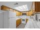 Functional kitchen with white appliances, bright lighting, and ample cabinet space at 5070 Jeffreys St # 101, Las Vegas, NV 89119