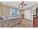 Carpeted bedroom with queen sized bed, ceiling fan, and natural light at 5335 Duralite St # 203, Las Vegas, NV 89122