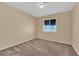 Neutral carpeted bedroom with a window and overhead light at 5335 Duralite St # 203, Las Vegas, NV 89122