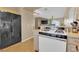 Kitchen featuring a gas range, refrigerator, and a seamless transition to the living area at 5335 Duralite St # 203, Las Vegas, NV 89122