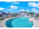 Community pool with chairs, tables, and mature landscaping at 5335 Duralite St # 203, Las Vegas, NV 89122