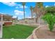 A spacious backyard offers a covered patio, well-manicured lawn, and hot tub at 57 Marion Dr, Las Vegas, NV 89110