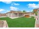 Expansive backyard featuring a covered patio and hot tub, ideal for relaxation and entertaining at 57 Marion Dr, Las Vegas, NV 89110