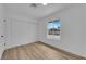 Bright bedroom featuring wood-look floors, closet and large window at 57 Marion Dr, Las Vegas, NV 89110