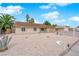 Charming home with desert landscaping, palm trees, and a rock with the house number at 57 Marion Dr, Las Vegas, NV 89110