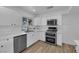 Bright kitchen featuring white cabinets, stainless steel appliances, and quartz countertops at 57 Marion Dr, Las Vegas, NV 89110