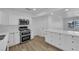 Well-lit kitchen featuring stainless steel appliances, white cabinetry, and ample counter space at 57 Marion Dr, Las Vegas, NV 89110
