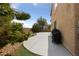 Backyard featuring a concrete patio, some grass, a grill, trees and landscaping at 6030 Hidden Summit St, North Las Vegas, NV 89031