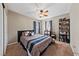 Comfortable bedroom with plush bedding, a ceiling fan, and a decorative bookshelf at 6030 Hidden Summit St, North Las Vegas, NV 89031