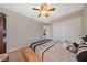 Carpeted bedroom featuring neutral walls, ceiling fan, double door closet, and queen-sized bed at 6030 Hidden Summit St, North Las Vegas, NV 89031