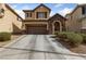 Charming two-story home features a stone-accented entrance, attached garage, and a well-maintained front yard at 6030 Hidden Summit St, North Las Vegas, NV 89031