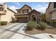 Charming two-story home features a stone-accented entrance, attached garage, and a well-maintained front yard at 6030 Hidden Summit St, North Las Vegas, NV 89031