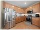 Well-equipped kitchen features stainless steel appliances, abundant cabinet space, and neutral countertops at 6030 Hidden Summit St, North Las Vegas, NV 89031