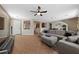 Open-concept living room with tile flooring, a comfortable sectional sofa, and an inviting atmosphere at 6030 Hidden Summit St, North Las Vegas, NV 89031
