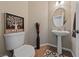 Cozy powder room features a pedestal sink, neutral walls, and decorative accents at 6030 Hidden Summit St, North Las Vegas, NV 89031