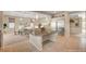 Open kitchen area with a large center island, dining area, and modern stainless steel refrigerator at 6257 Olde Lockford Ct, Las Vegas, NV 89139