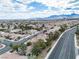 Panoramic aerial shot of a sprawling suburban community with mountain views in the distance at 8112 Broken Spur Ln, Las Vegas, NV 89131