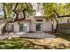 Spacious backyard features a concrete patio area, mature trees, and privacy at 8112 Broken Spur Ln, Las Vegas, NV 89131