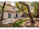 Large backyard with a concrete patio, mature trees, and a sense of secluded tranquility at 8112 Broken Spur Ln, Las Vegas, NV 89131