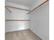 Walk-in closet with wooden shelving and carpet at 8112 Broken Spur Ln, Las Vegas, NV 89131