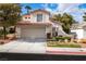 Charming home featuring a two-car garage, well-manicured lawn, and desert landscaping at 8112 Broken Spur Ln, Las Vegas, NV 89131