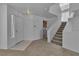 Open entryway with stairs, neutral carpet, and access to the laundry room at 8112 Broken Spur Ln, Las Vegas, NV 89131