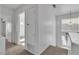 Upstairs hallway with neutral carpet, multiple doorways and a decorative light fixture at 8112 Broken Spur Ln, Las Vegas, NV 89131