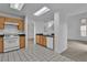 Kitchen with white appliances, wood cabinets, and a view into the living area at 8112 Broken Spur Ln, Las Vegas, NV 89131