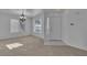 Bright living room with neutral carpet, a front door, and large windows at 8112 Broken Spur Ln, Las Vegas, NV 89131
