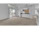 Bright living room featuring neutral carpet, high ceilings, and sliding glass doors to the backyard at 8112 Broken Spur Ln, Las Vegas, NV 89131